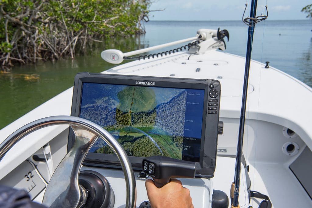 boater using their ISLA GPS fishing map while driving their boat