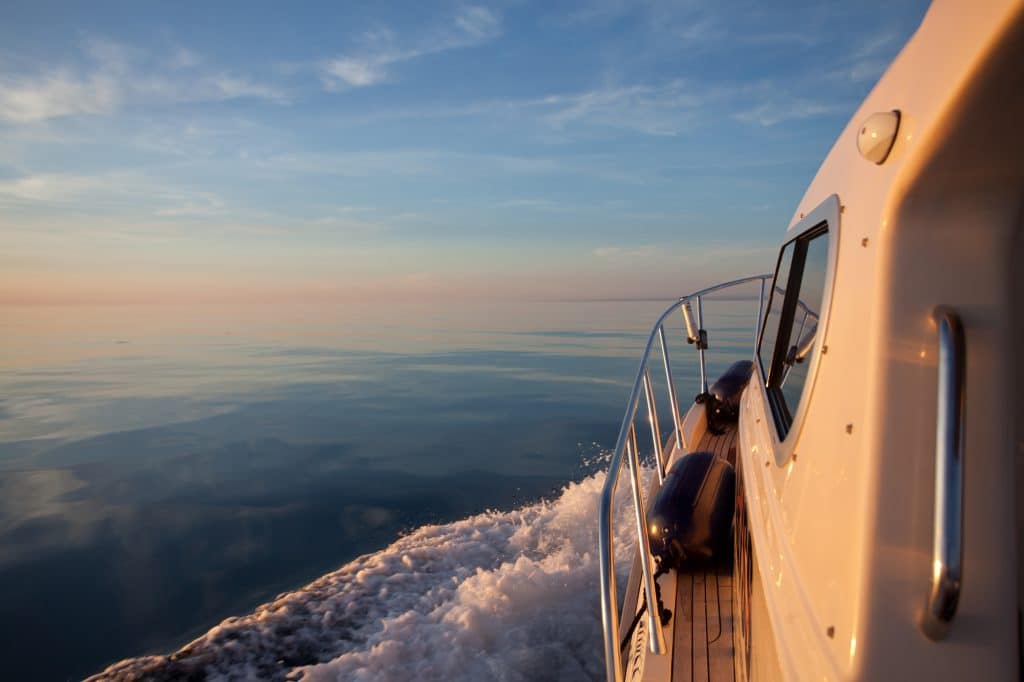 side of boat sailing toward the horizon